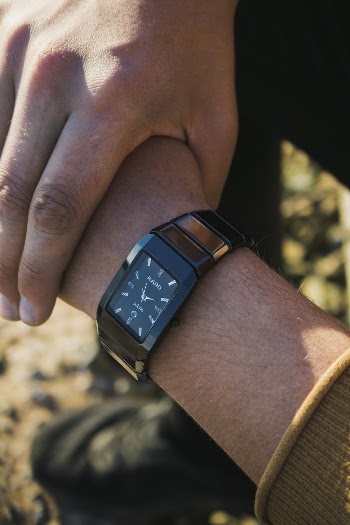 Person Wearing Black Watch at Right Wrist