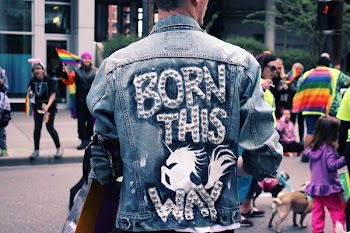 person wearing blue denim jacket walking on park