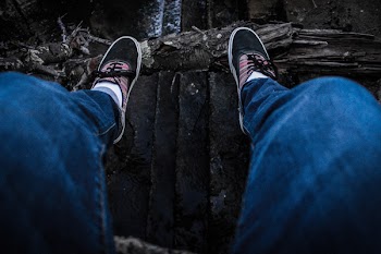 Person Wearing Blue Denim Jeans Above Black Surface