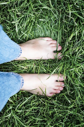 Person Wearing Blue Denim Jeans Standing On Green Grass