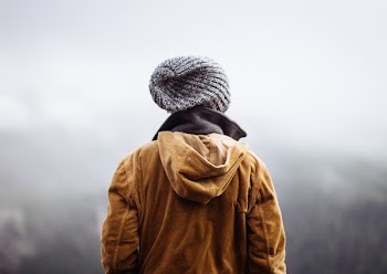 person wearing brown jacket