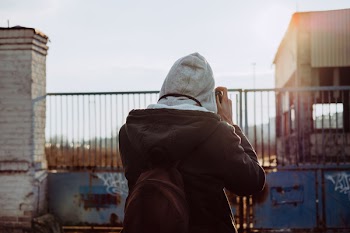 Person Wearing Brown Jacket Taking Photo