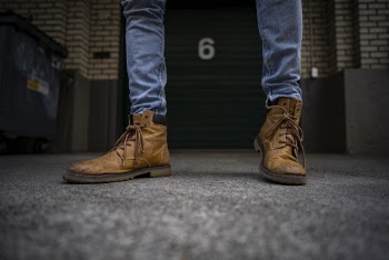 Person Wearing Brown Leather Boots Standing on the Street