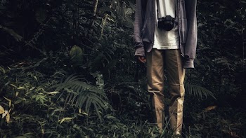 Person Wearing Brown Pants and Purple Jacket