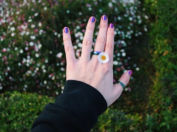 Person Wearing Daisy Flowerring With Purple Nails