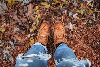 Person Wearing Distressed Blue Denim Jeans and Brown Leather Boots Standing