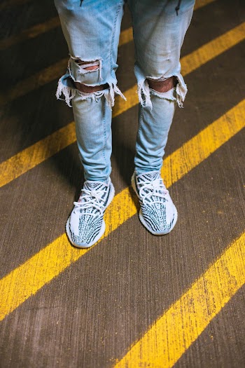 Person Wearing Distressed Denim Jeans