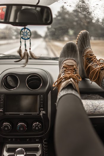 Person Wearing Duck Boots Inside Vehicle