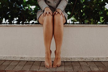 Person Wearing Gray Long-sleeved Mini Dress in Front of Green Leaf Plant