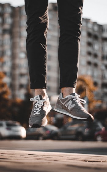 Person Wearing Gray New Balance Shoes