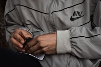 person wearing gray Nike zip-up top