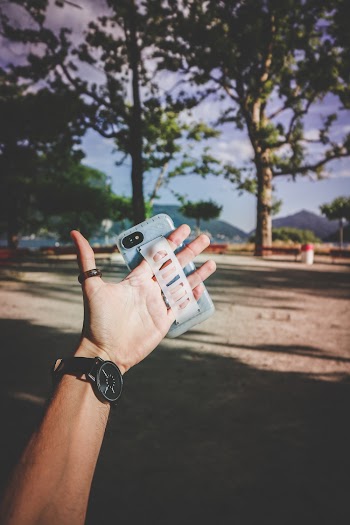 Person Wearing Gray Smartphone Case