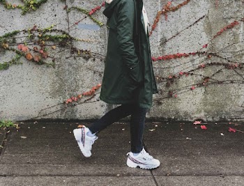 Person Wearing Green Coat and Rubber Shoes
