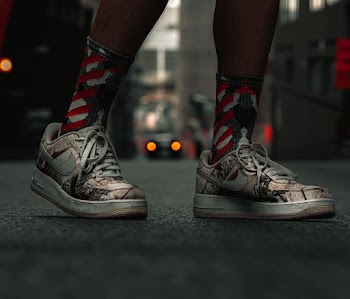 Person Wearing Grey-and-black Nike Sneakers