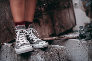 Person Wearing Grey High Top Sneakers Standing On Hollow Blocks