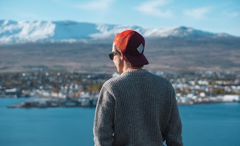 Person Wearing Grey Knit Sweater and Red Cap
