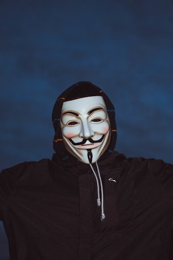 Person Wearing Guy Fawkes Mask and Hoodie
