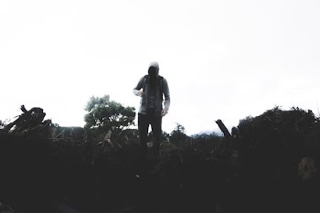 person wearing hoodie standing on field