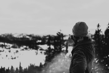 Person Wearing Jacket Pointing the Glacier Mountain