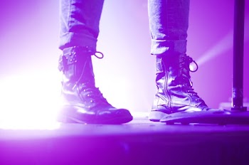 Person Wearing Lace Up Boots Standing on Stage