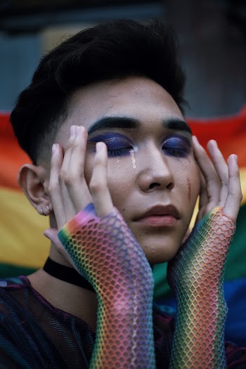Person Wearing Multicolored Net Gloves