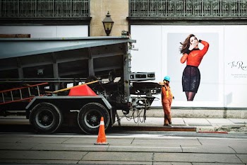 person wearing orange suit while leaning on truck