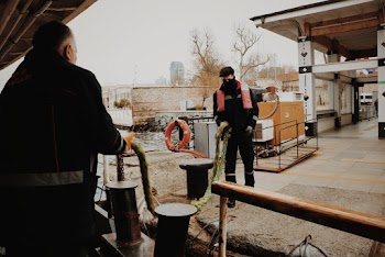 Person Wearing Orange Vest Holding Green Rope