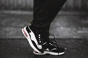 Person Wearing Pair of Black-and-white Runnning Shoes