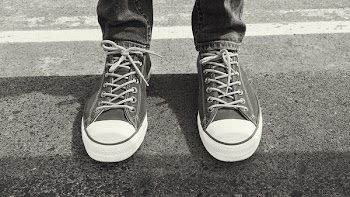 Person Wearing Pair of Black Lace-up Sneakers