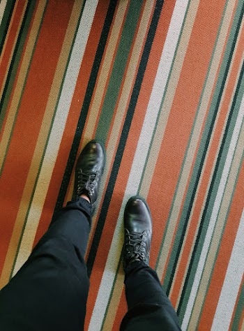 Person Wearing Pair of Black Leather Lace-up Dress Shoes