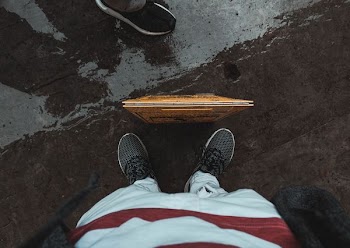 person wearing pair of black sneakerrs