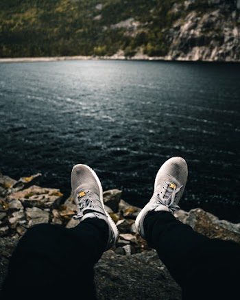 Person Wearing Pair of Gray Running Shoes