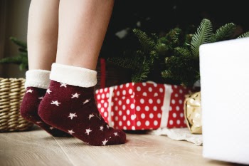 Person Wearing Pair of Maroon Star Printed Socks