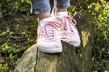 Person Wearing Pink Adidas Low-top Sneakers
