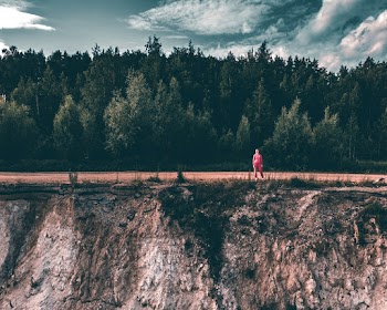 Person Wearing Pink Pants Standing Besides Cliff