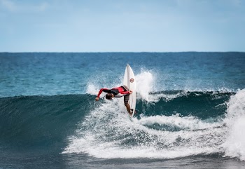 Person Wearing Red and Black Wetsuit Wave Surfing