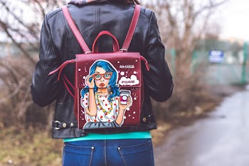 Person Wearing Red and Multicolored Leather Backpack