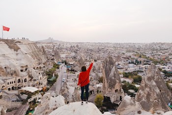 Person Wearing Red Long-sleeved Shirt Standing on Rock