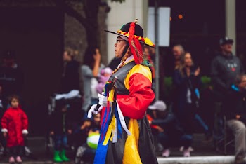 Person Wearing Red, Yellow, and Green Dress