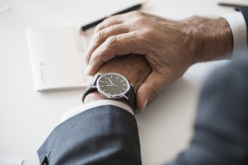 Person Wearing Round Analog Watch With Black Strap