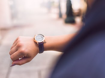 Person Wearing Round Gold Watch With Black Leather Strap