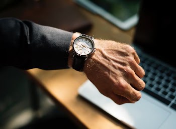 person wearing round white watch