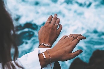 person wearing silver-colored rings
