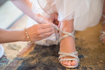 Person Wearing Unpaired White Sandal in Selective Focus Photography