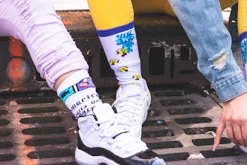 Person Wearing White and Black Air Jordan 11 Shoe