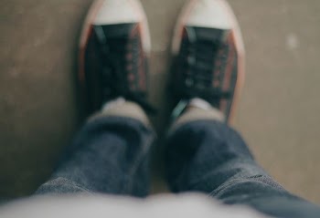 person wearing white-and-black low-top sneakers