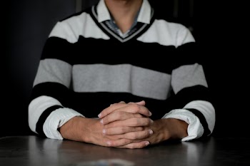 Person Wearing White and Black Striped Sweater Sitting