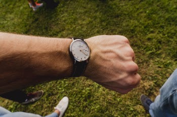 Person Wearing White and Black Watch