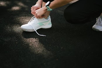 Person Wearing White Low-Top Sneakers