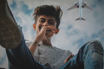 Person Wearing White Shirt and Blue Jeans
